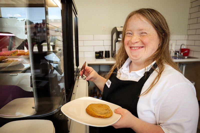 Rose Cat Coffee Co Barista Kelsi Serving Rose Cat's famous brown butter chocolate chip cookies.